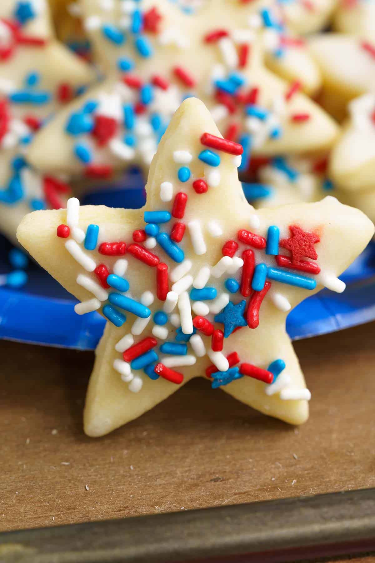 Honey almond glazed cookies showing jimmies on top of the glazed star.