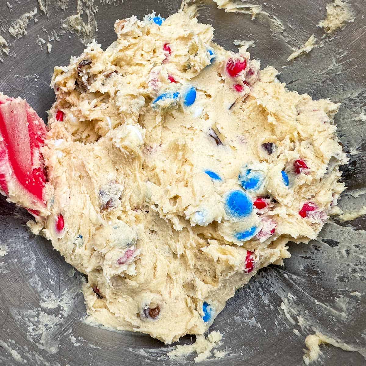 The completed cookie dough with MMs sticking out everywhere.