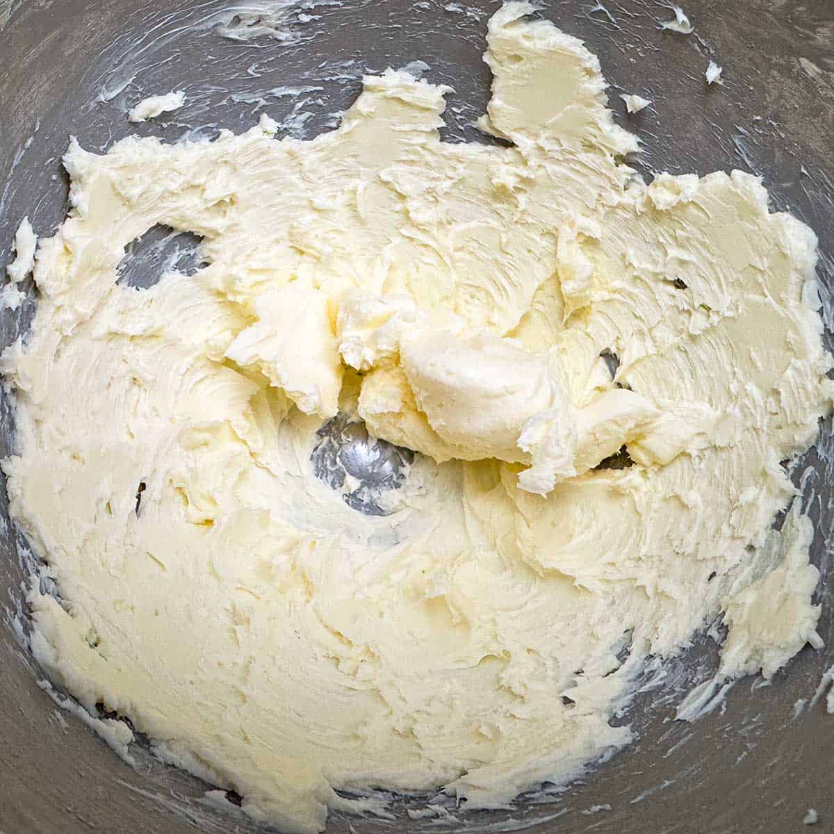 Creamed butter in a mixer bowl.