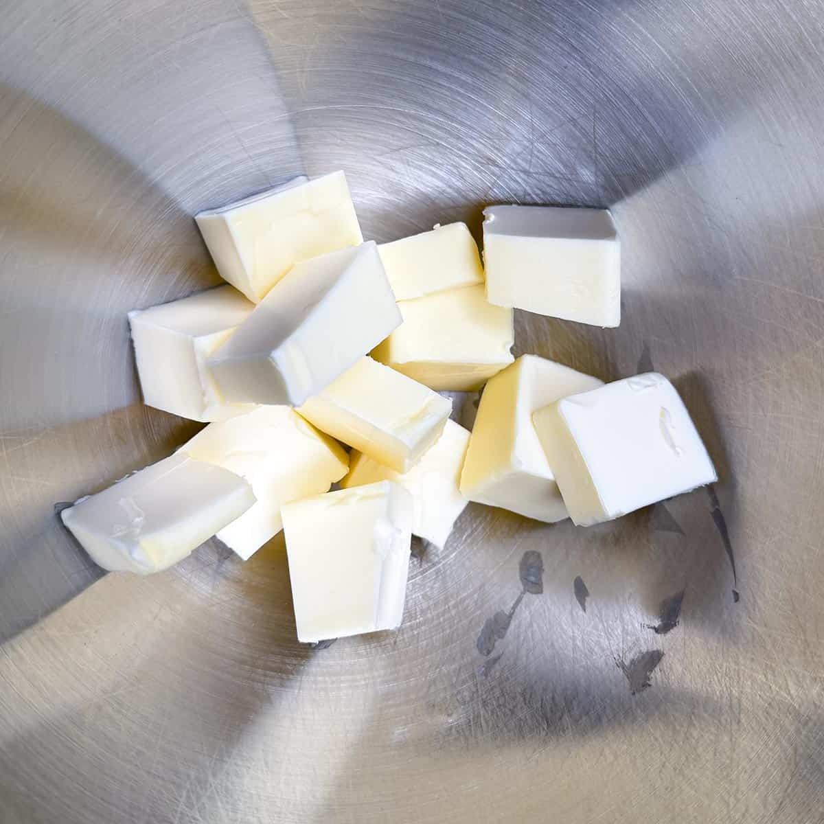 Cubed butter in a mixer bowl ready to be creamed.