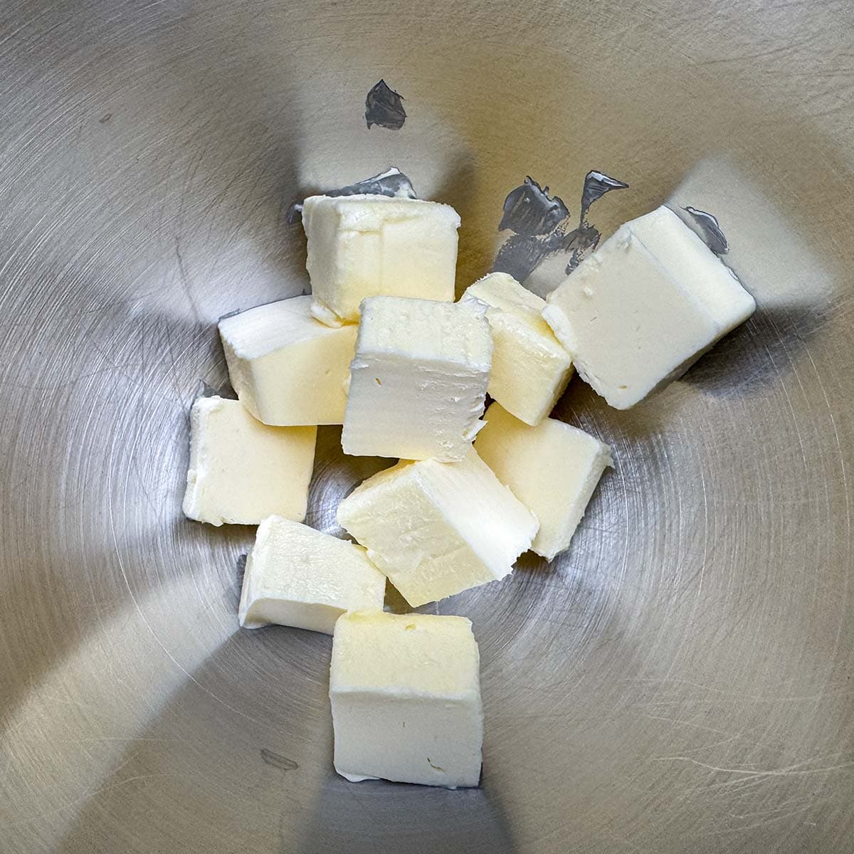Cubed butter in a mixer bowl.