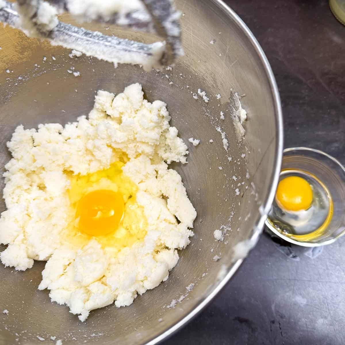 Adding eggs to the butter-sugar mixture.