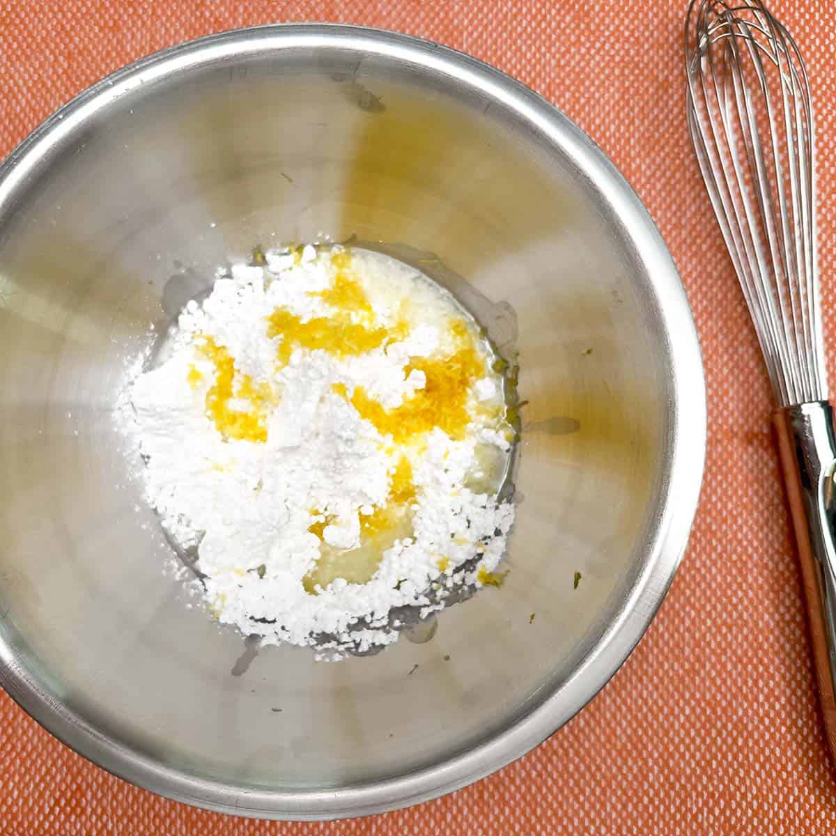 Powdered sugar, lemon zest, and juice for the glaze. Using a whisk to blend.