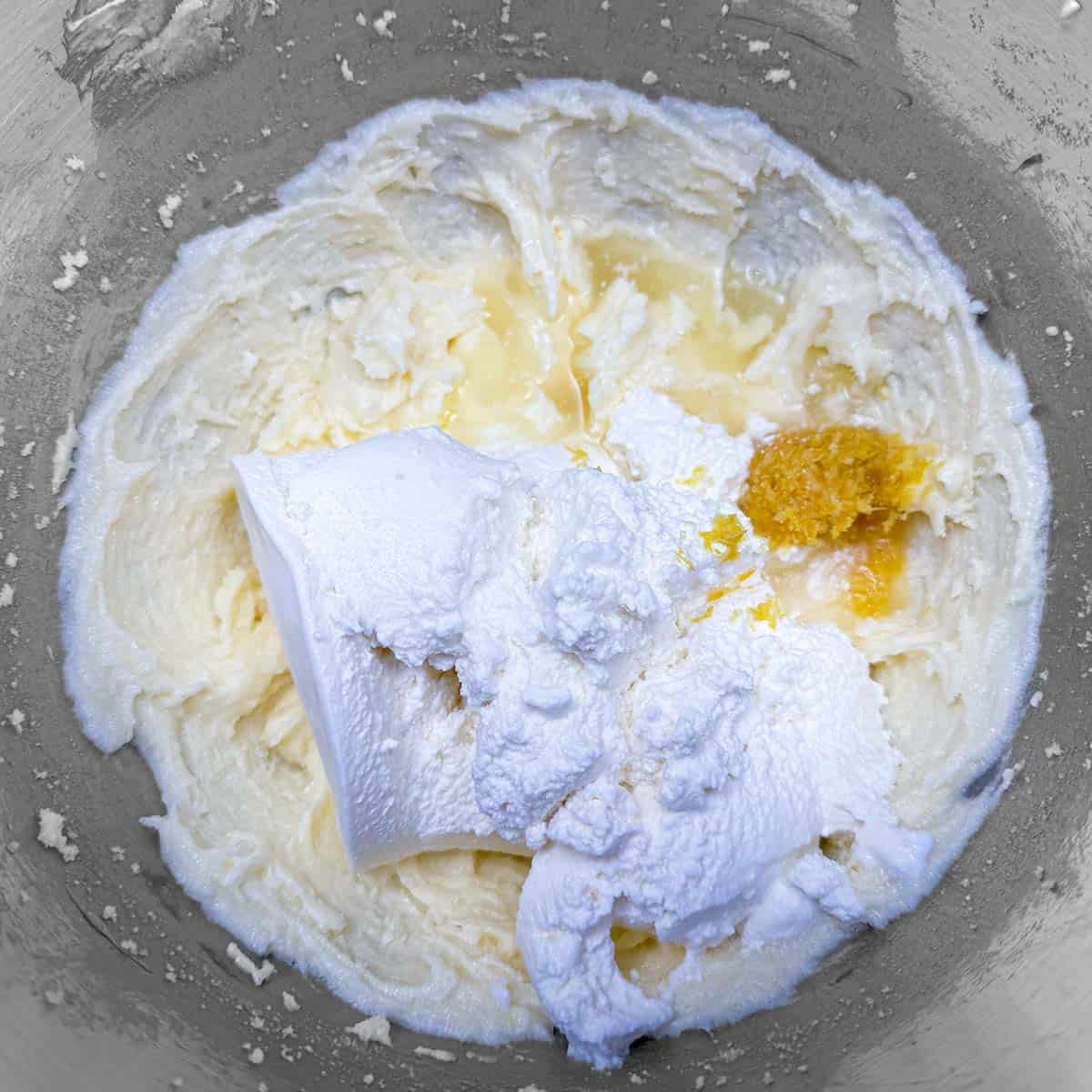 Adding the ricotta and lemons to the rest of the cookie mixture.