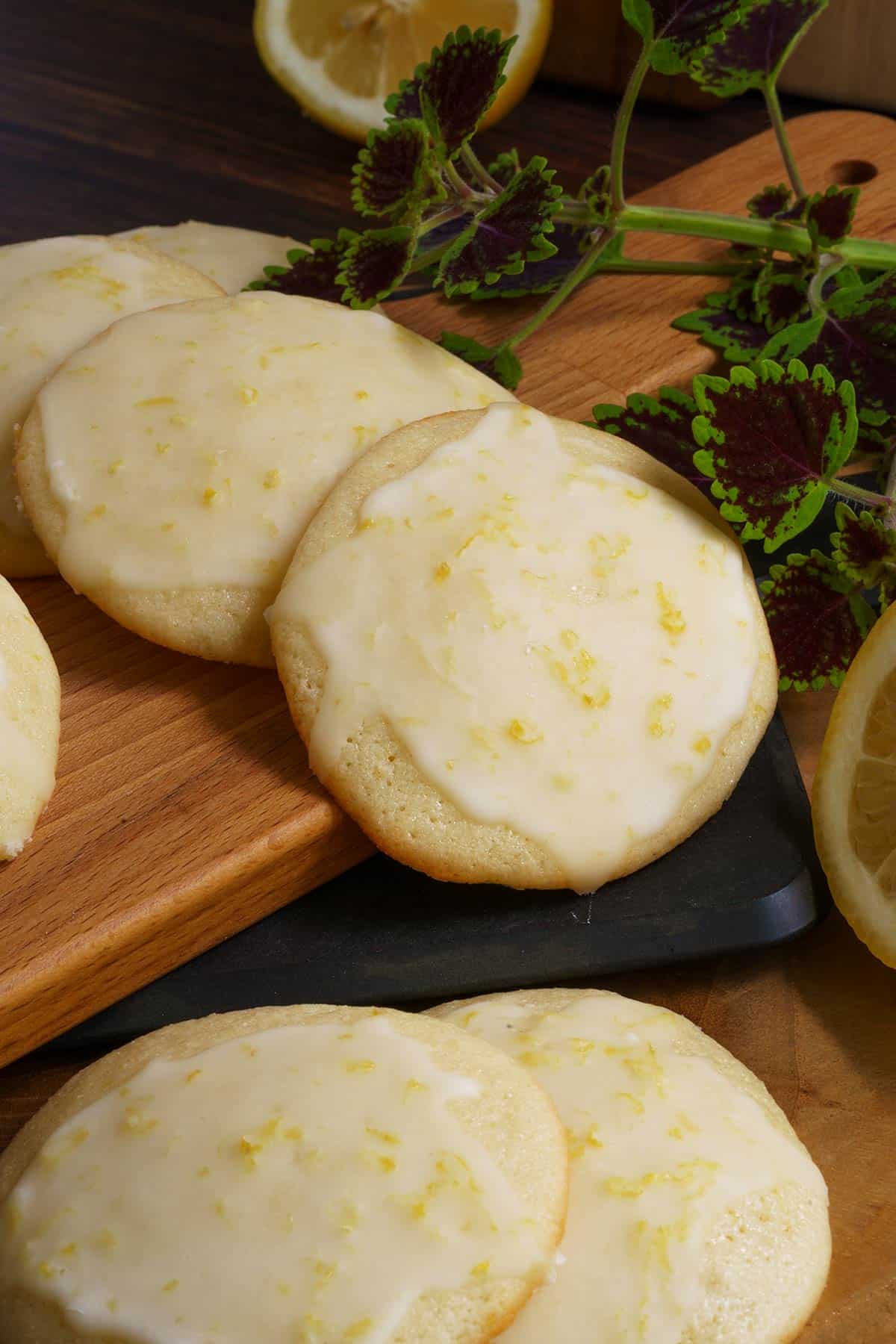 My Real Lemon Ricotta Cookies arranged on cutting boards with peeks of cut lemons on the side.