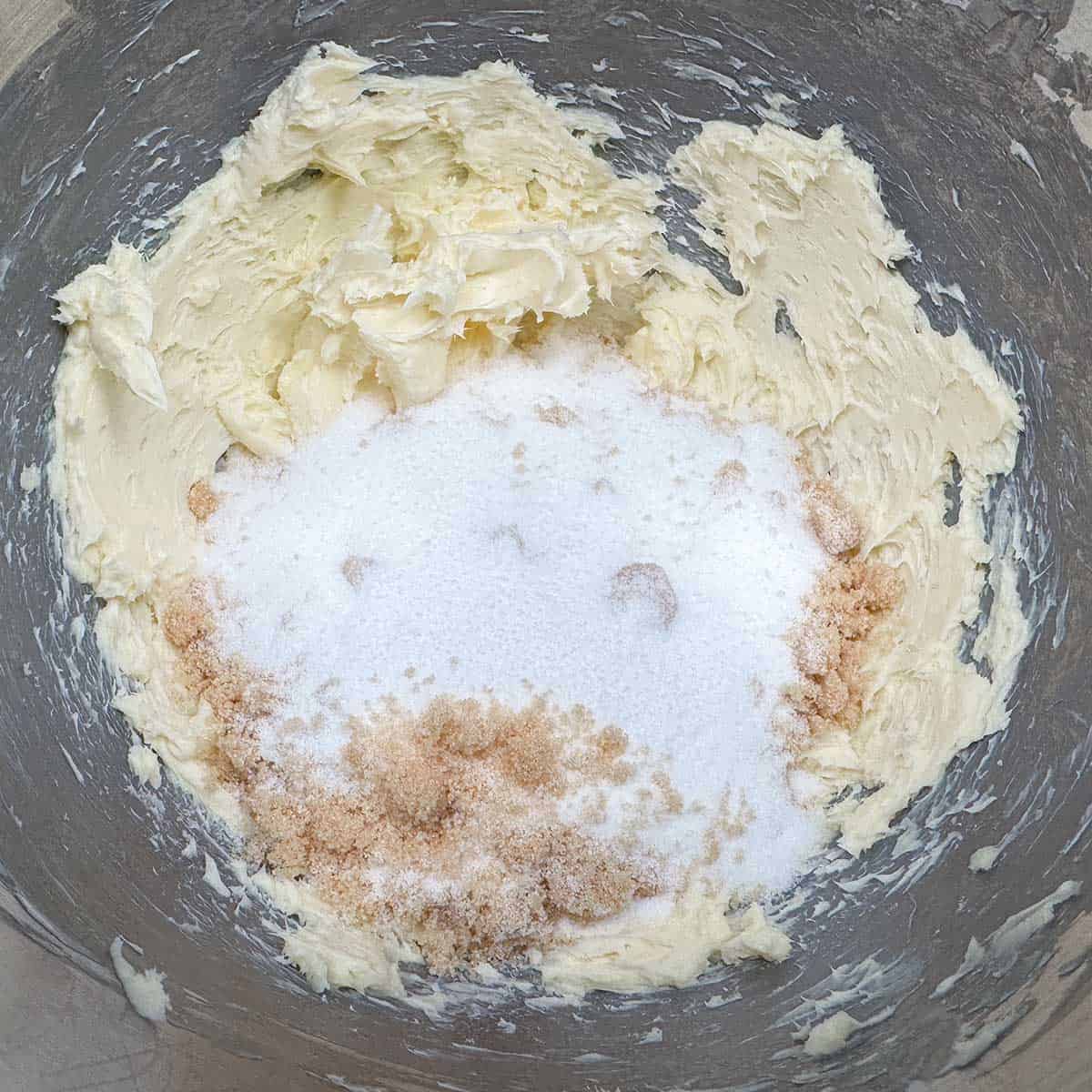 Adding both sugars to the creamed butter.