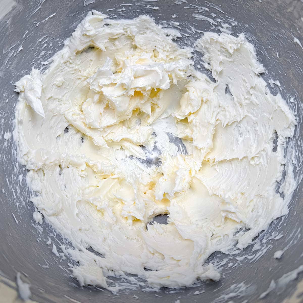 Creaming the butter in the mixer bowl.