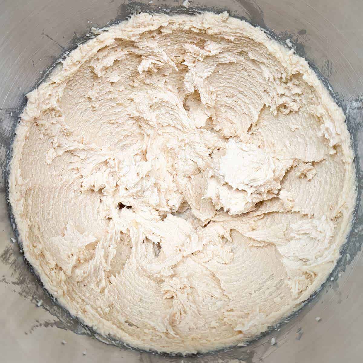 In a mixer bowl the creamed butter has been mixed with both sugars.