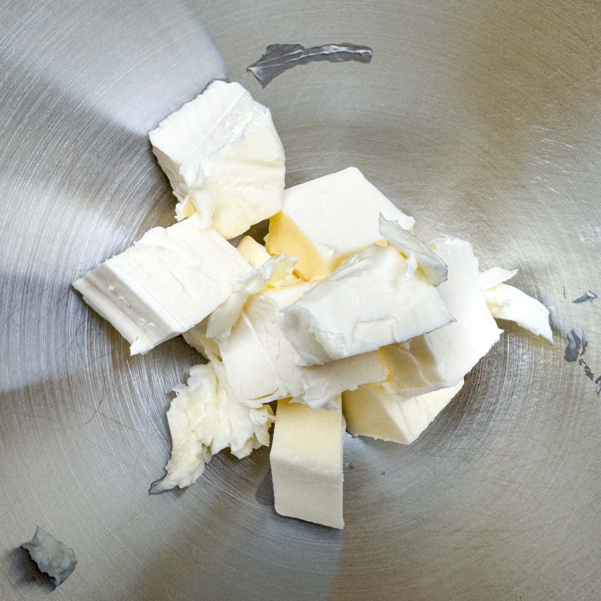Cubed butter in a mixer bowl.