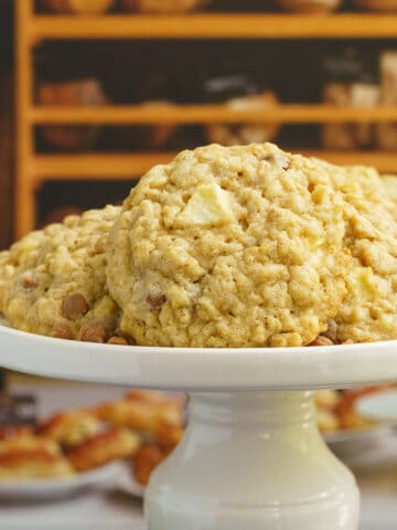 Apple caramel oatmeal cookies on a pedestal for feature photo.