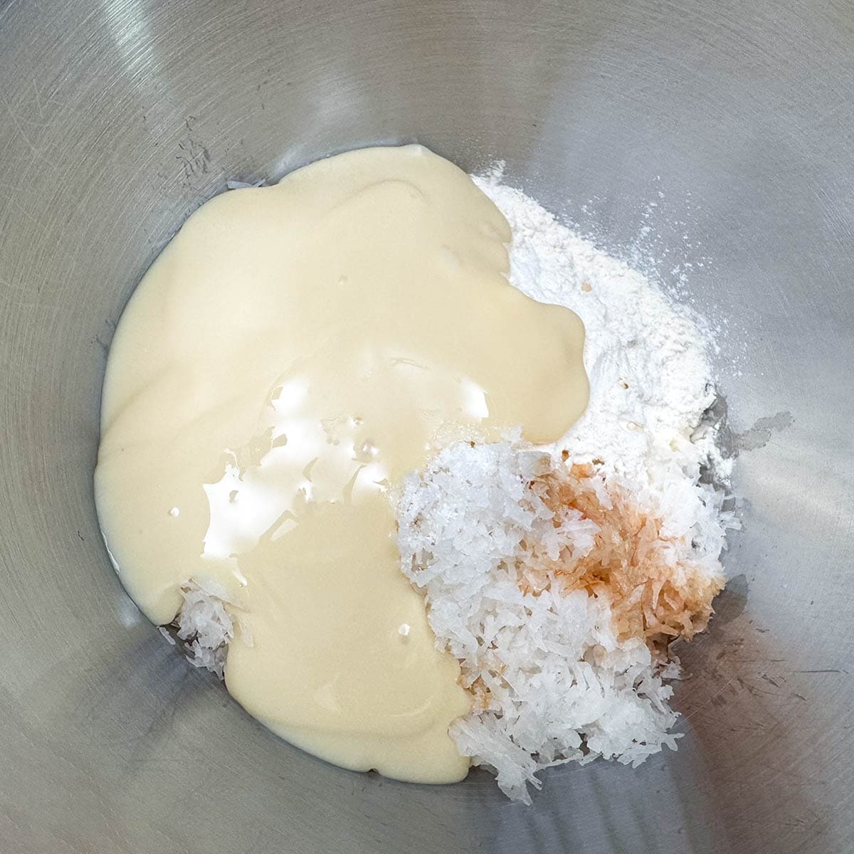 All the ingredients are adding to the mixing bowl at the same time.