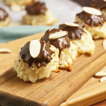 A line of easy creamy coconut macaroons on a wooden plank.