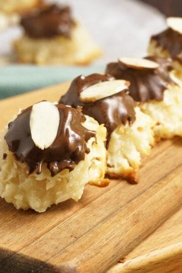 A line of easy creamy coconut macaroons on a wooden plank.