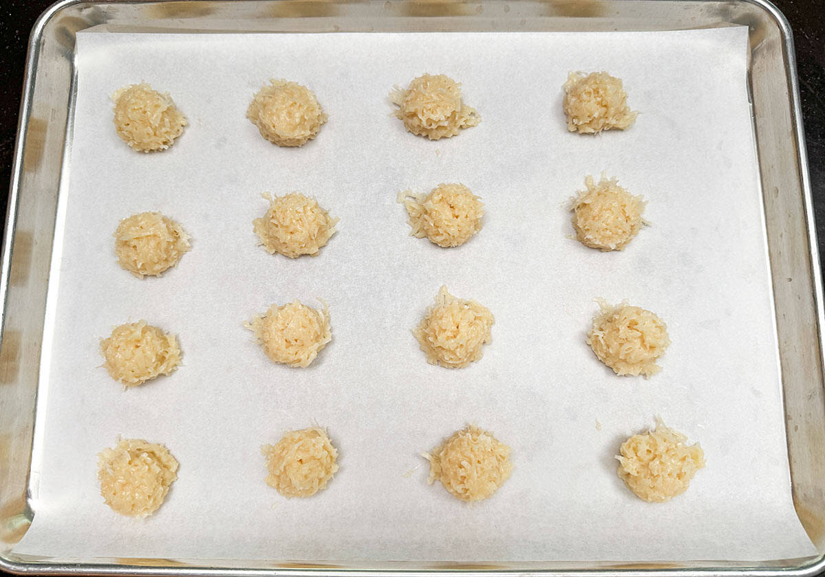 Scoop and shape coconut macaroons onto a parchment-lined cookie sheet pan.