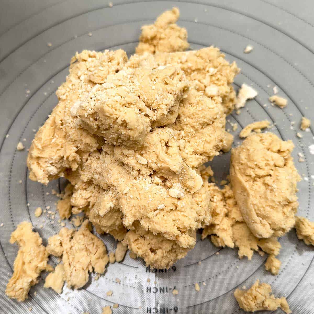 Flour mixture add and then placed on a pastry mat to finish incorporating the flour.