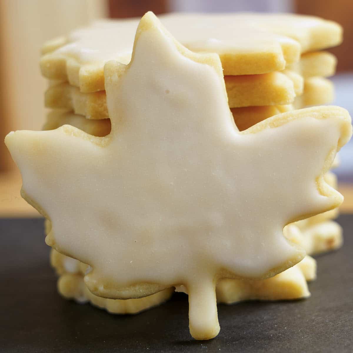 Double Maple Sugar Cookies that are stacked and one full view in front of the stack.