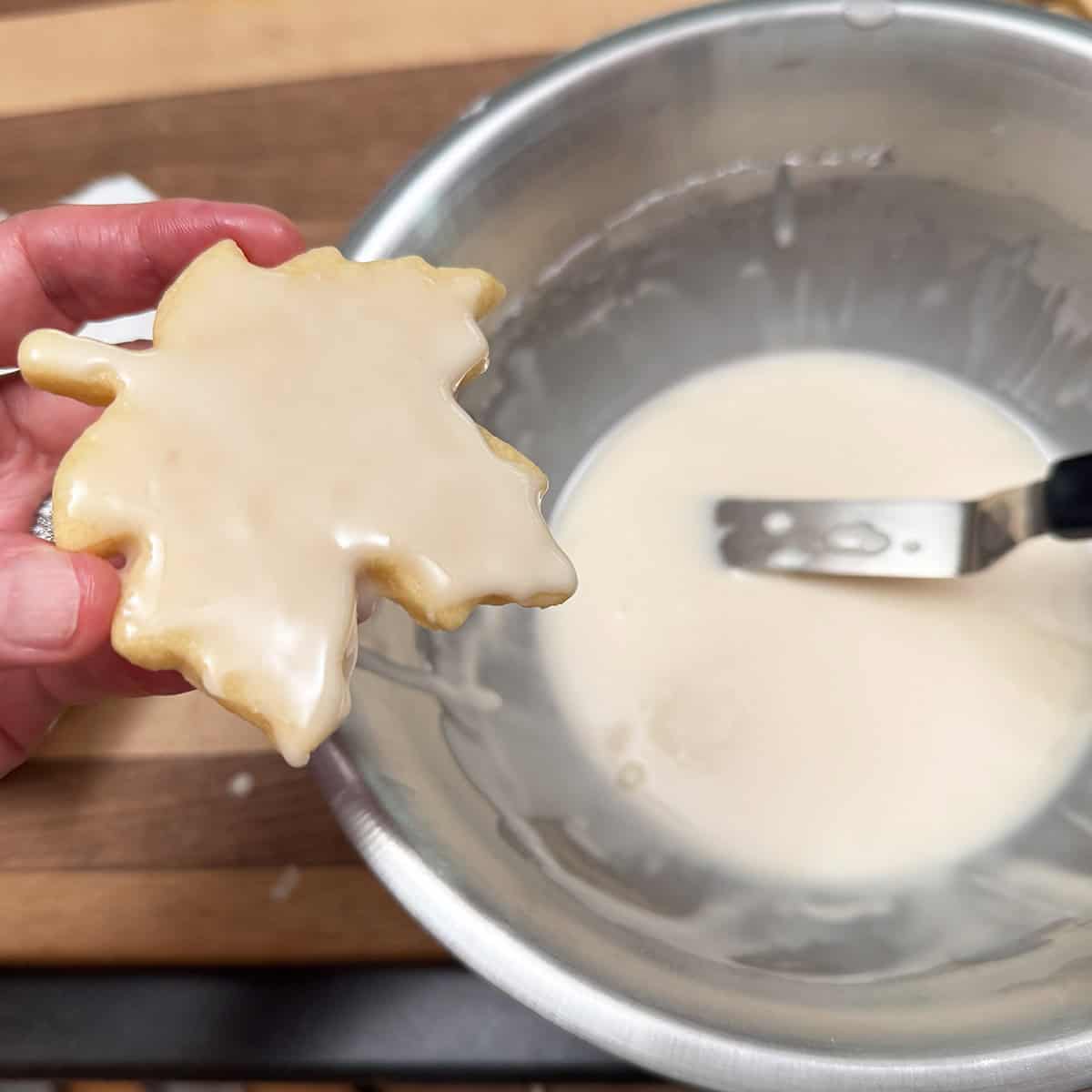 Using an icing knife to add and smooth the glaze.