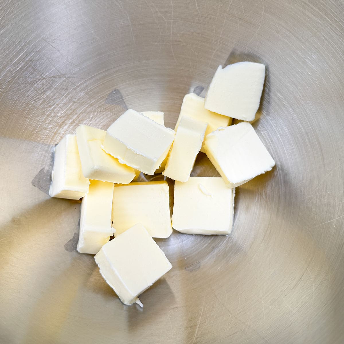 Cubed butter in a mixer bowl.