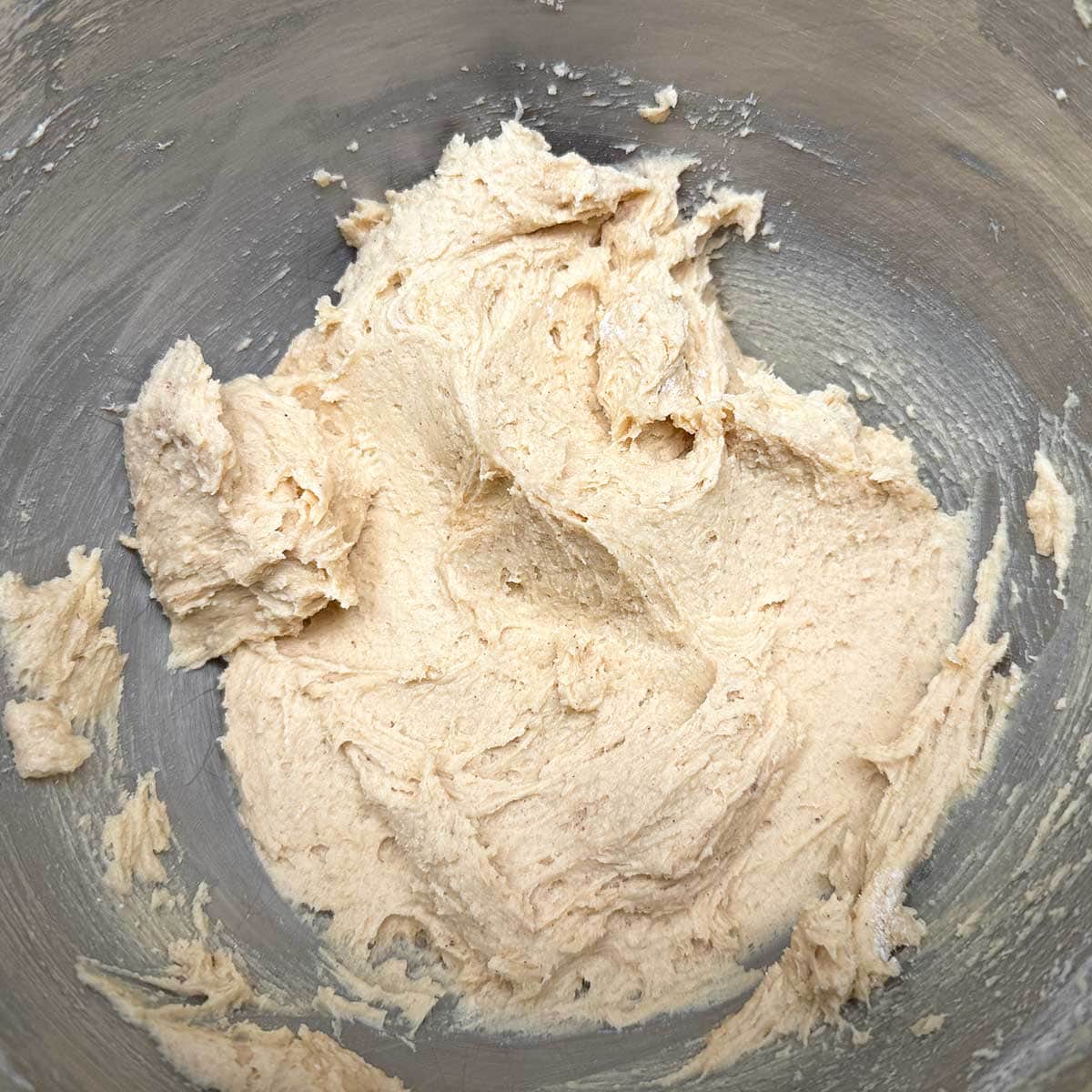 A creamy cookie dough after the flour mixer has been added.
