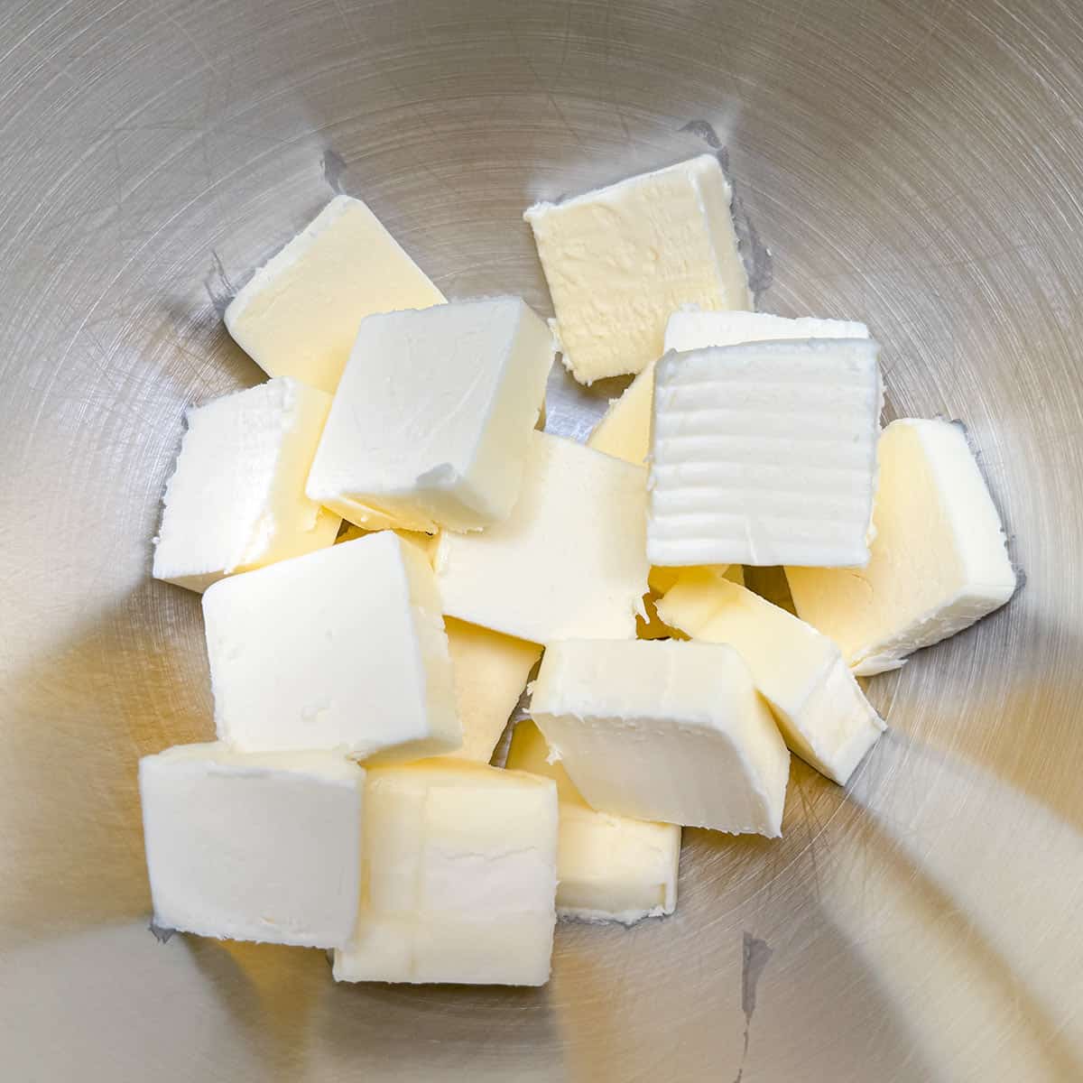 Cubed butter in a mixer bowl.
