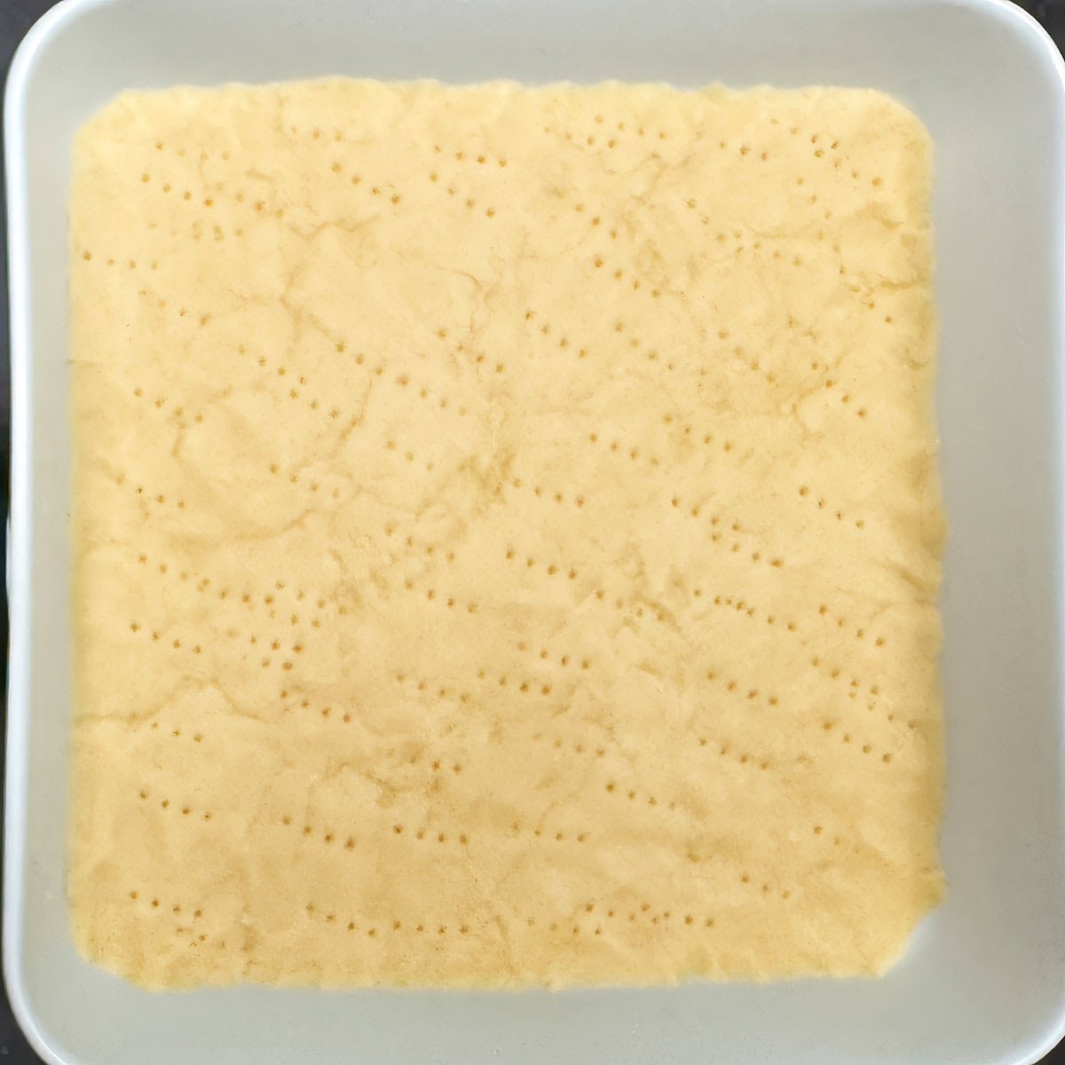 Fork imprints on the shortbread bottom crust before par-baking.