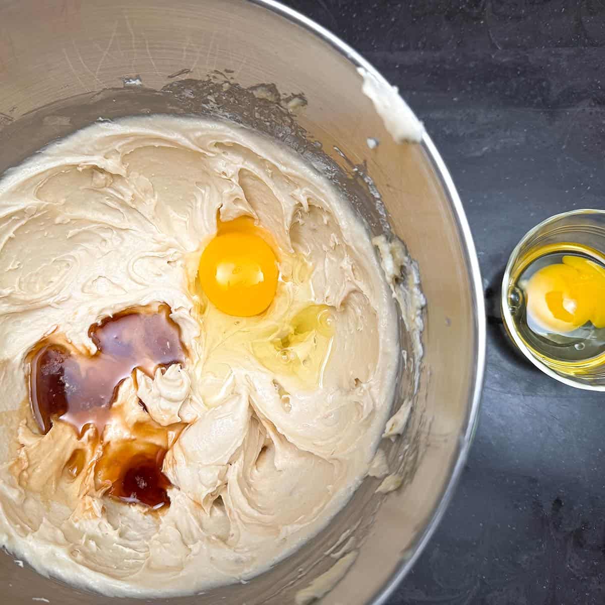 Adding the maple syrup, vanilla extract and one of the two eggs.