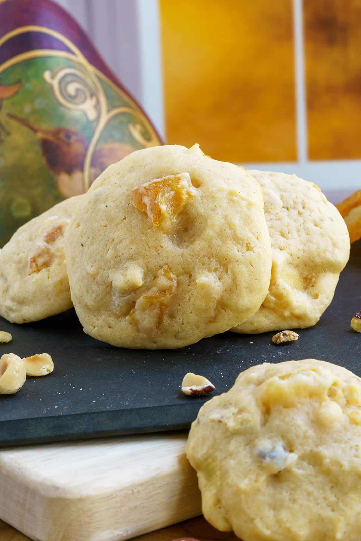 Several Pear and Hazelnut Cookies on several cutting boards that are stacked.