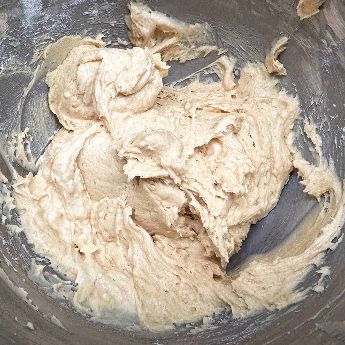 Cookie dough after the flour mixture has been added. Slightly soft but still holding its shape.
