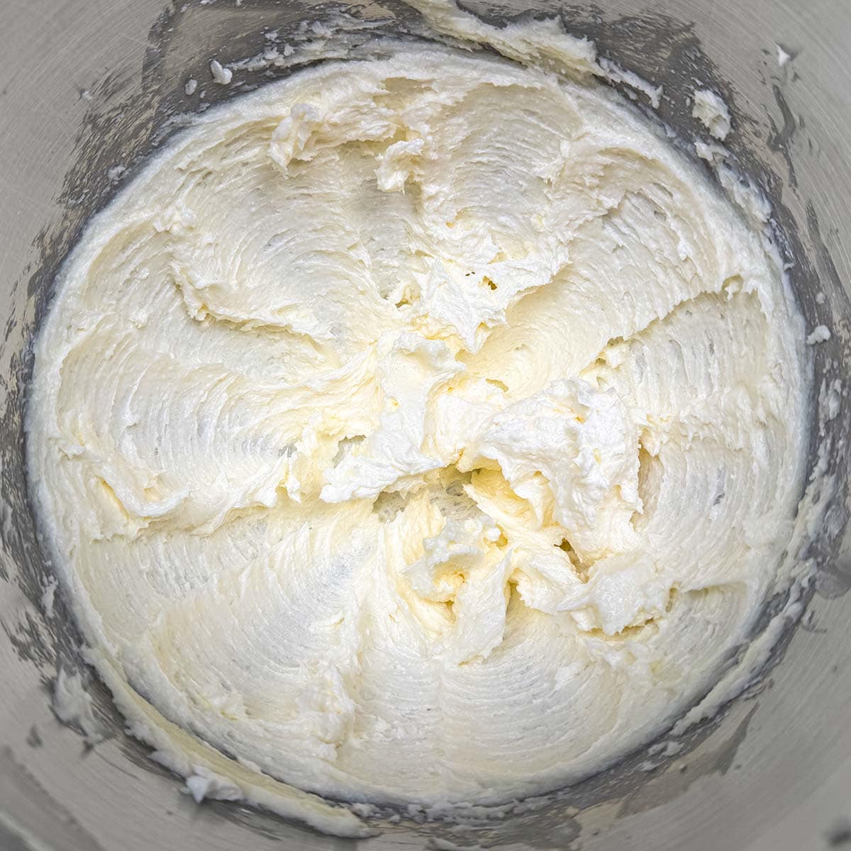 Soft swirled butter that has been creamed in a mixer bowl.