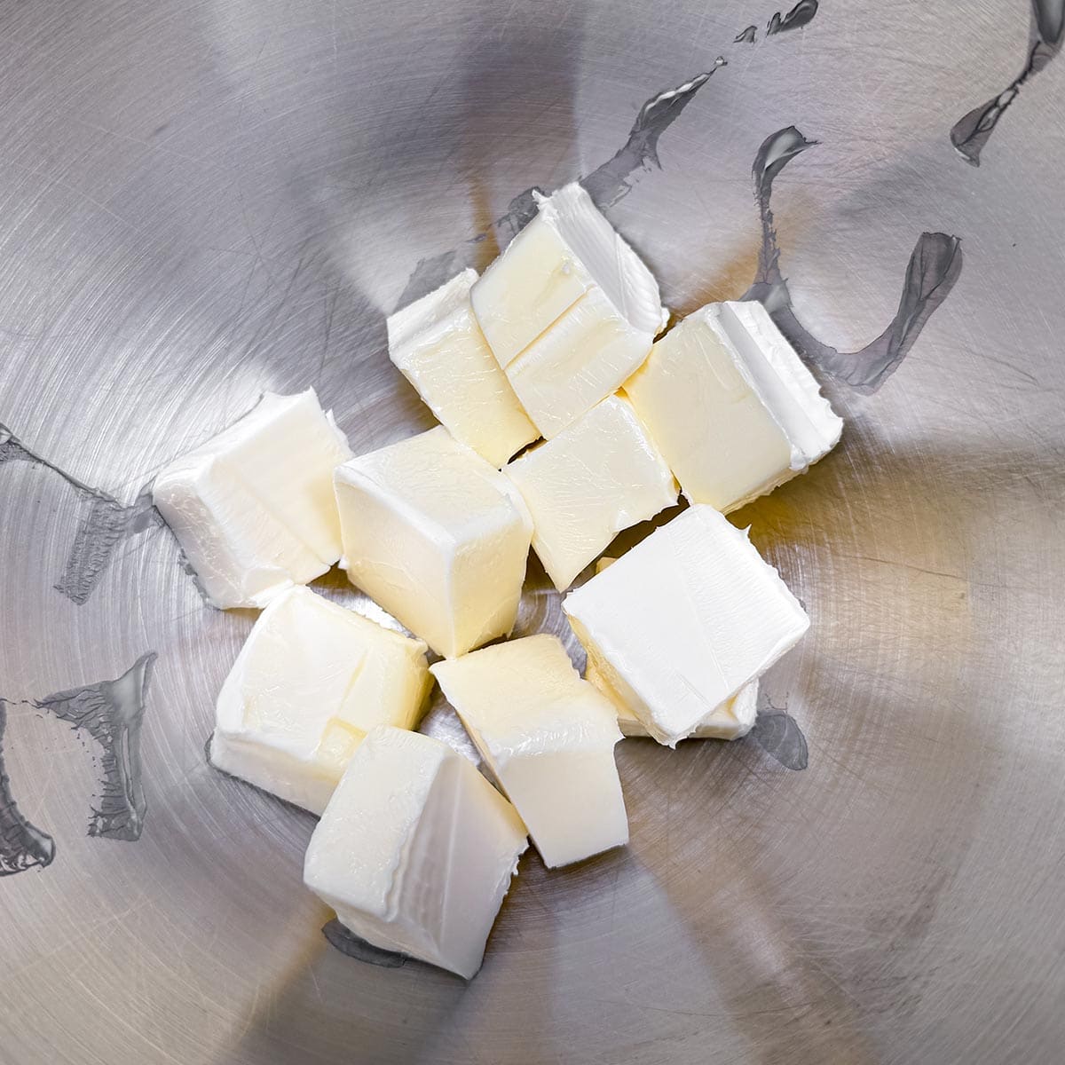 Cubed butter in a mixer bowl.
