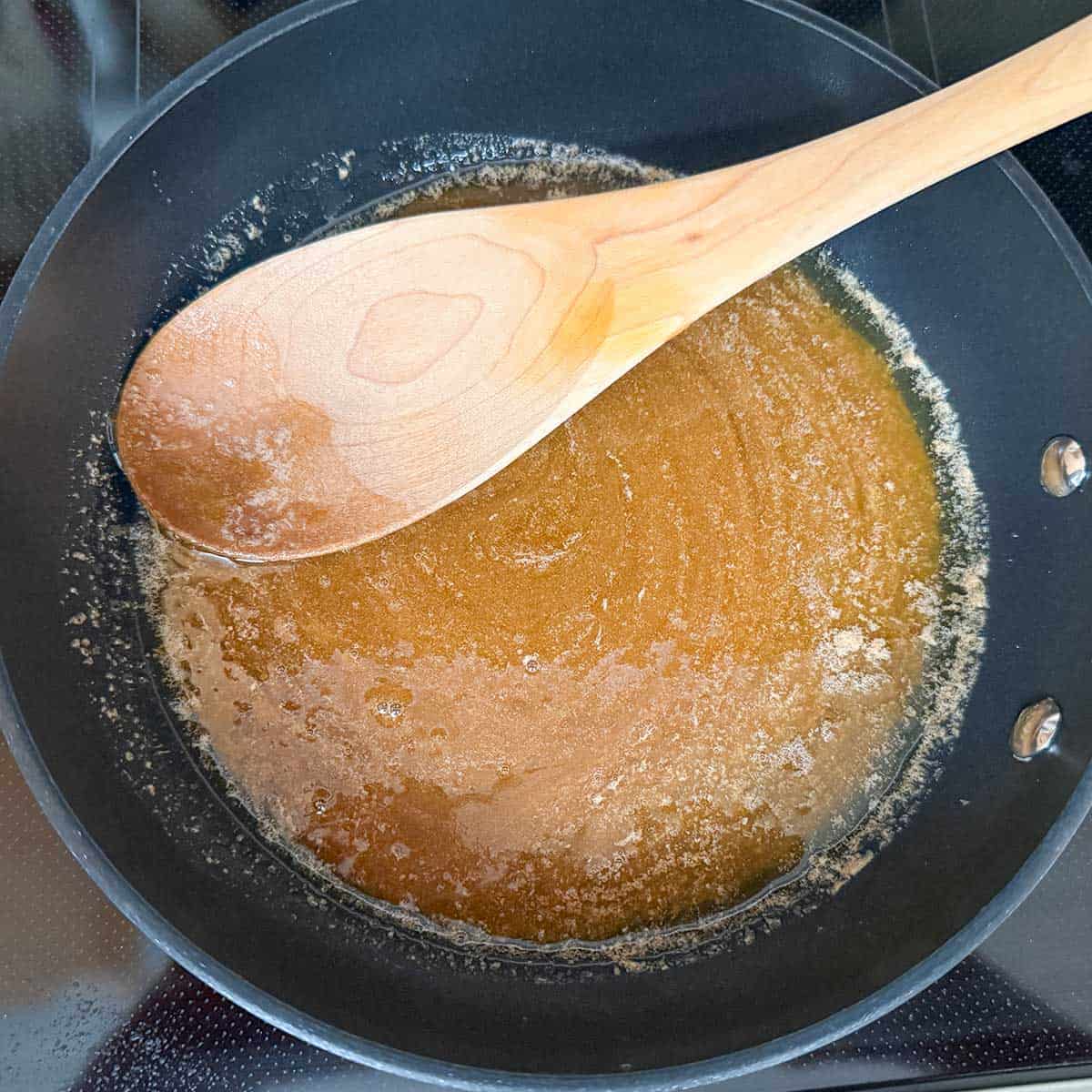Melting the brown sugar, butter, salt, and cinnamon in a small frying pan.