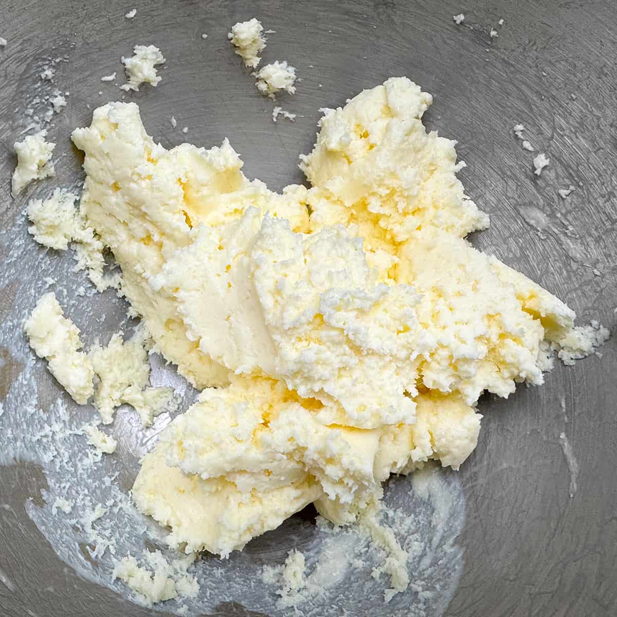Mixed butter and mascarpone in a mixer bowl.