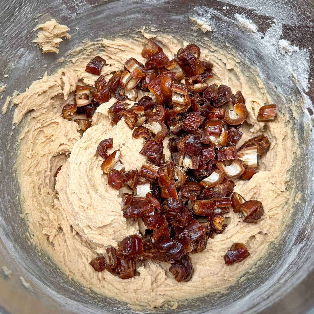 Adding the cut up dates to the cookie dough.
