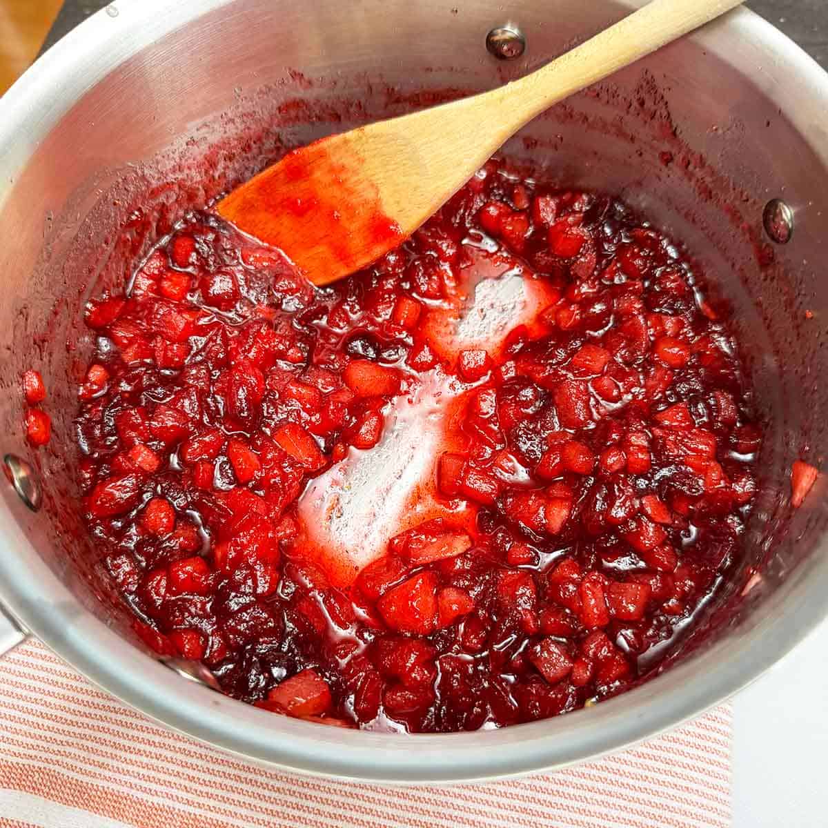 To tell if the jam is ready pull the spoon across the bottom of the pan and it should stay clean.