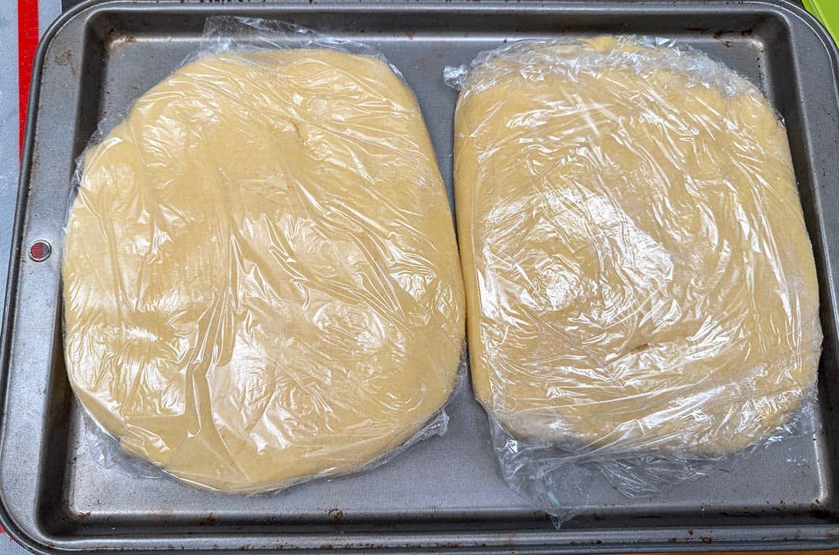 Cookie dough divided into to parts and flattened and wrapped. Ready for the 2 hour chill.