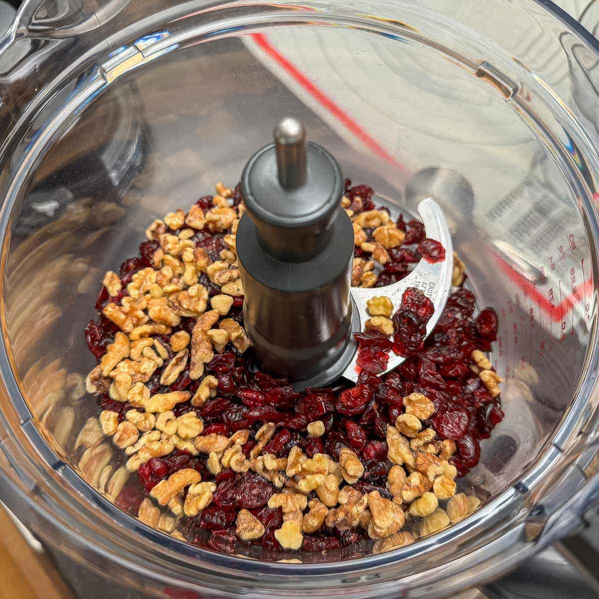 Dried cranberries and walnuts in the food processor to get minced.