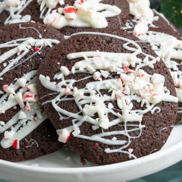 Close up of a peppermint mocha cookie with drizzle of white chocolate and chopped peppermint pieces on top of the drizzle.