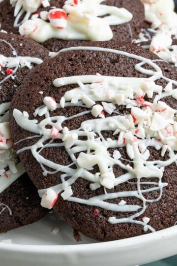 Close up of a peppermint mocha cookie with drizzle of white chocolate and chopped peppermint pieces on top of the drizzle.