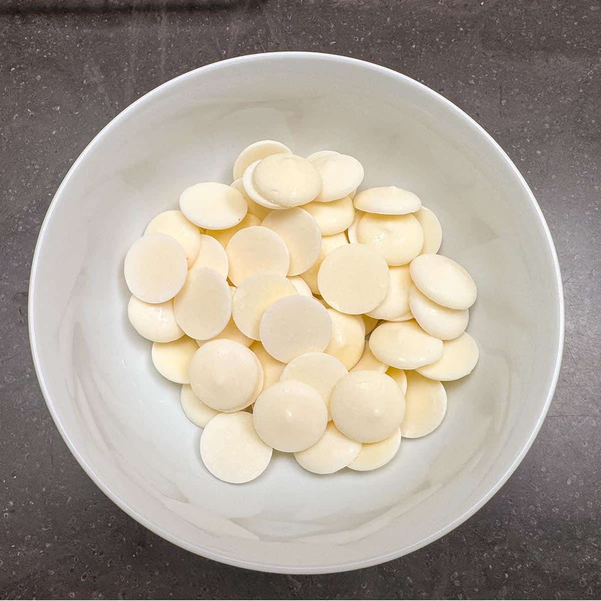 White chocolate wafers in a bowl.