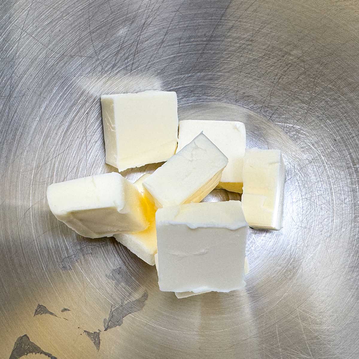 Cubed butter in a mixer bowl ready to be creamed into soft peaks.