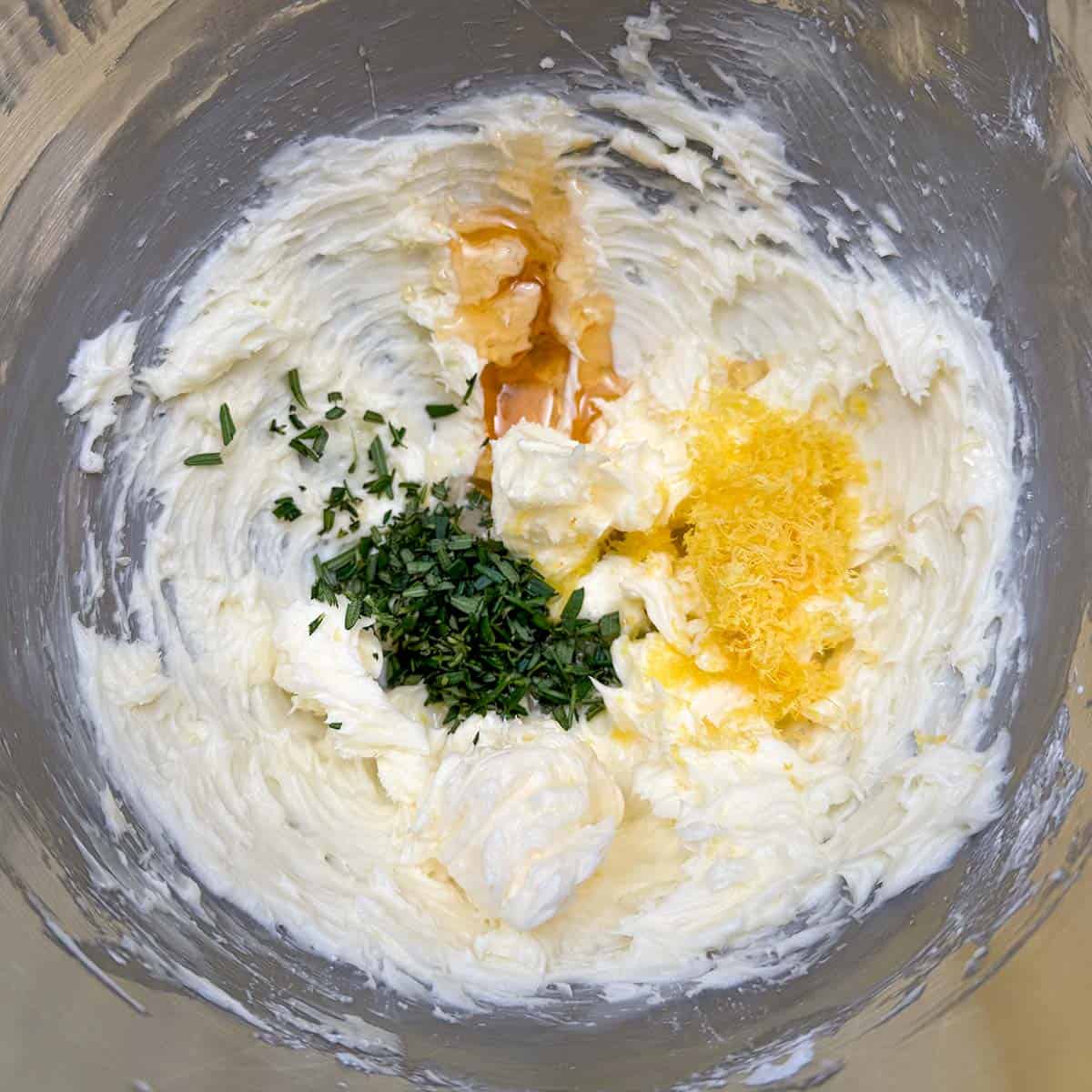 Adding the fresh diced rosemary, honey and lemon juice and zest to the butter-sugar mixture.