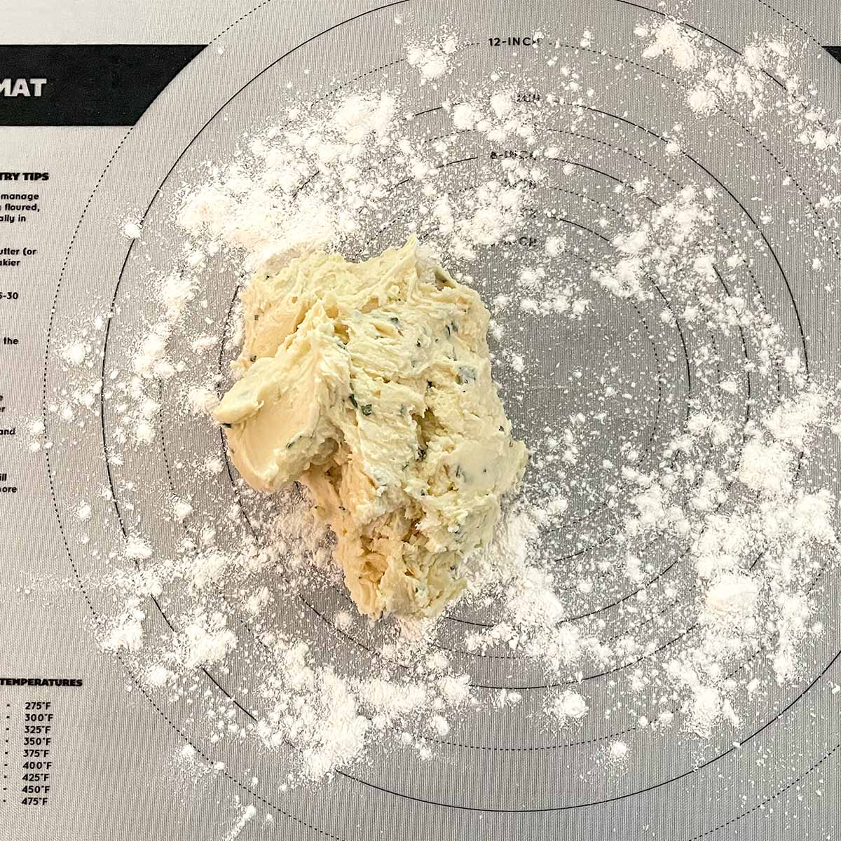 Cookie dough on powdered sugared mat.