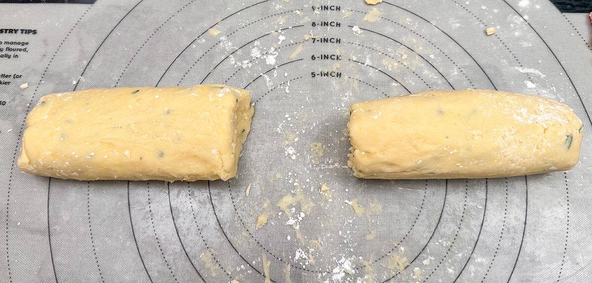 Cookie dough split in half to be wrapped in plastic wrap and then chilled.