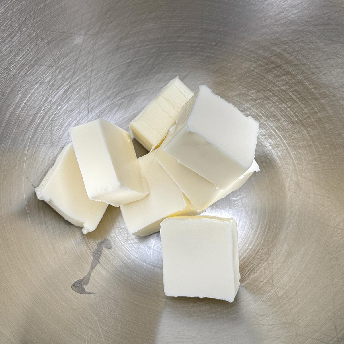 Cubed butter in a mixer bowl.
