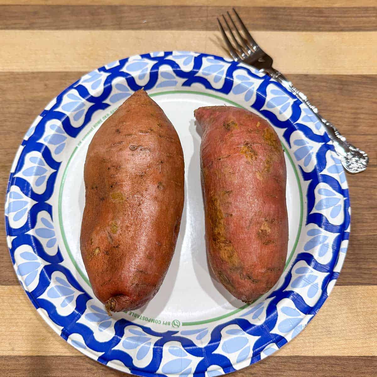 Buttered outside sweet potato skins and ready to be microwaved.