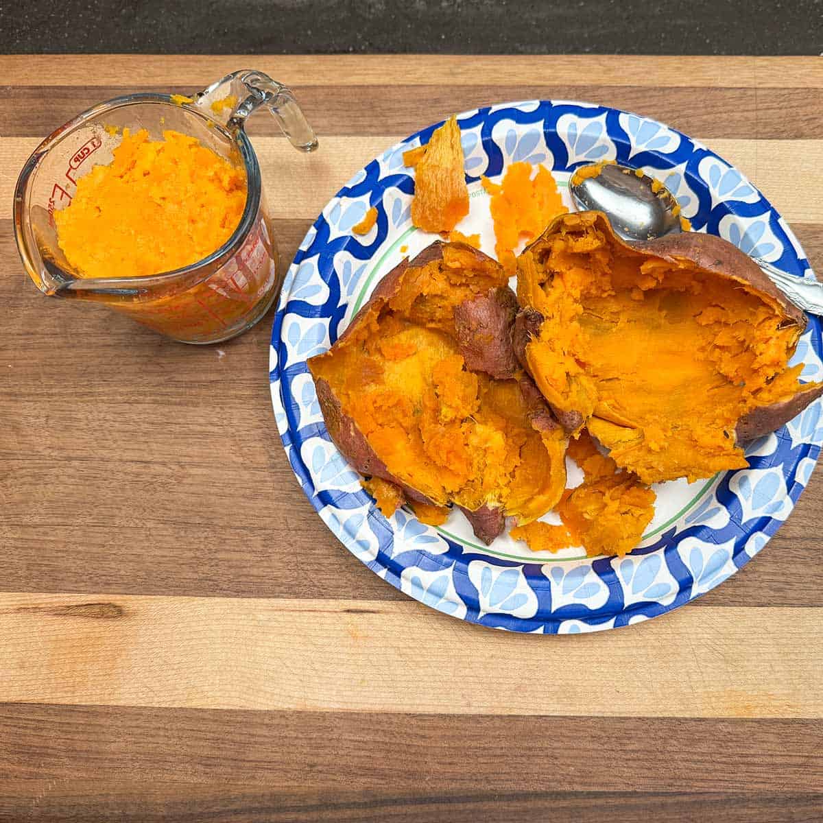 Scooping out the sweet potatoes from the outside skins.
