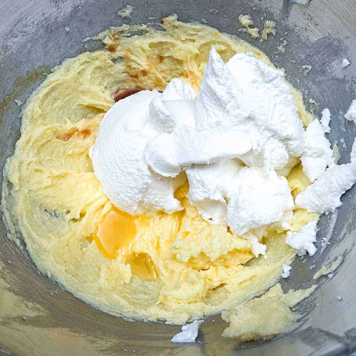 Getting ready to mix into the butter-sugar mixture the ricotta cheese, orange juice, and vanilla extract.