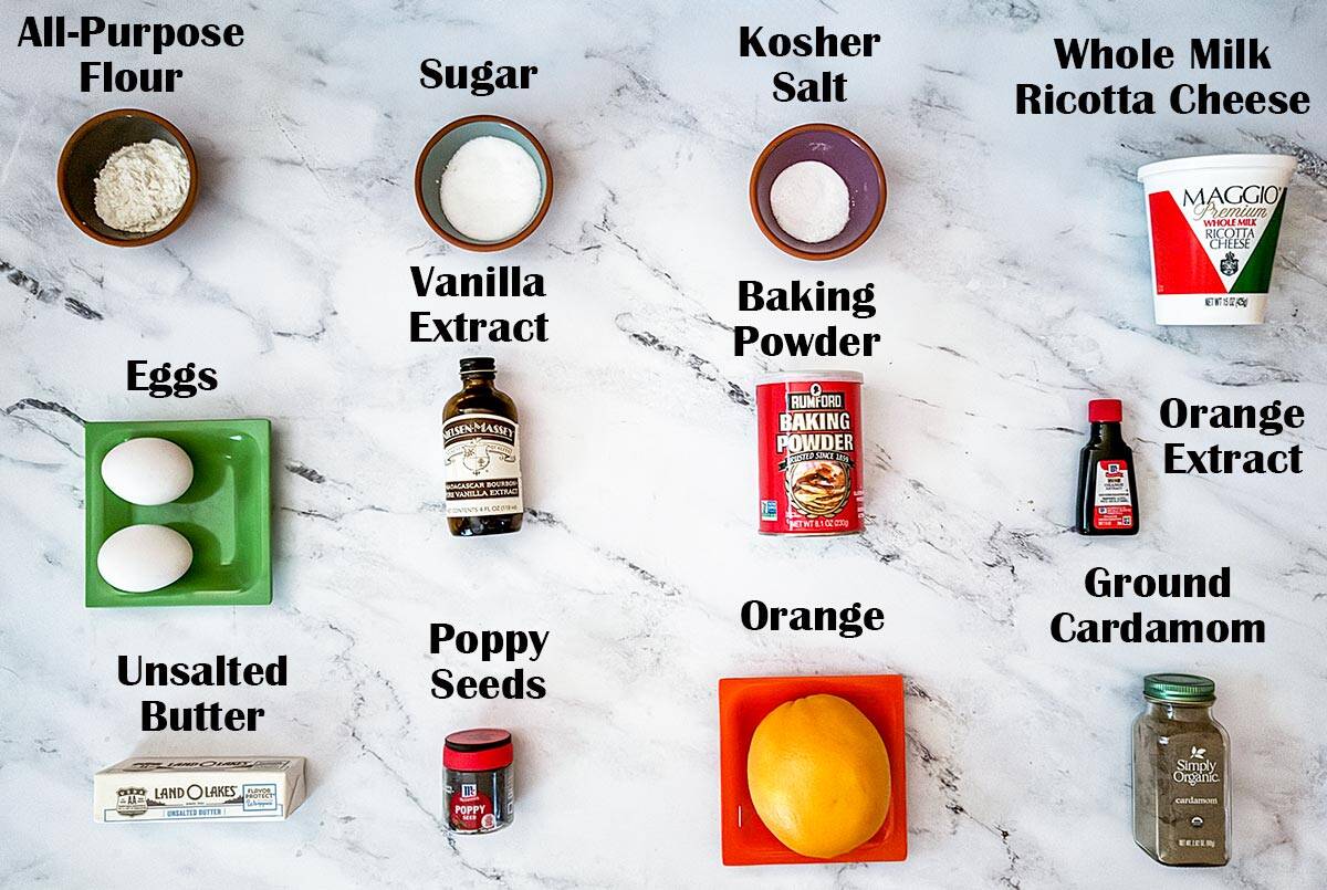 Each ingredient for the ricotta orange cookies is laid out and named. Listed below.