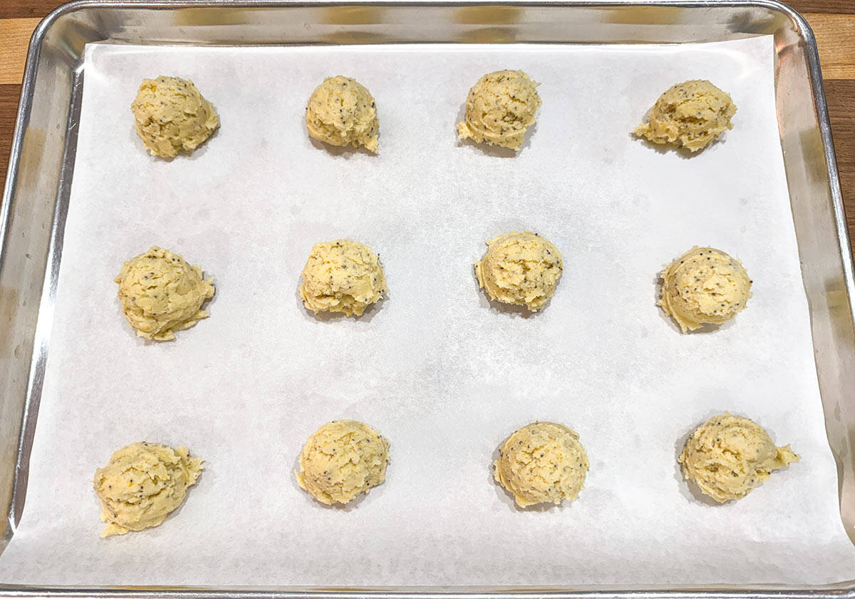 Scooped cookie dough on a parchment lined sheet pan and ready for the oven.