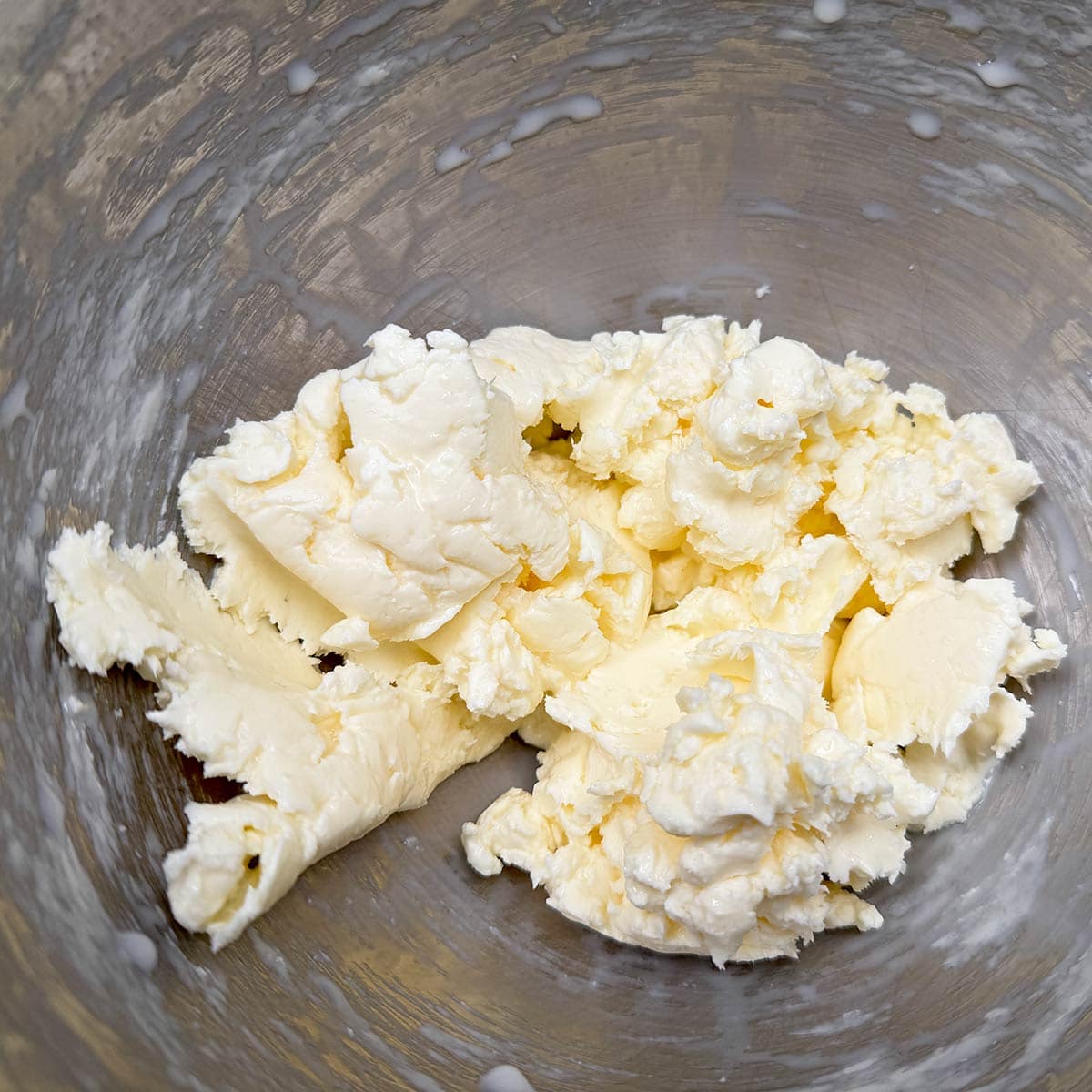 Butter and creamed cheese mixed in a mixer bowl.